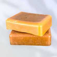 Load image into Gallery viewer, Two bars of golden-orange soap stacked on a light gray background